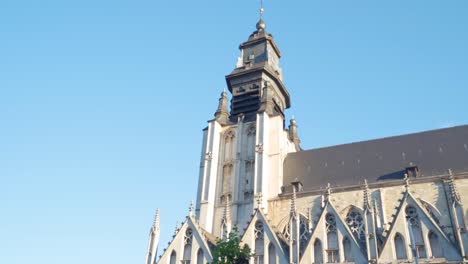 old medieval roman catholic church of our blessed lady of sablon in brussels, belgium with sunlight shining on it on warm sunny day