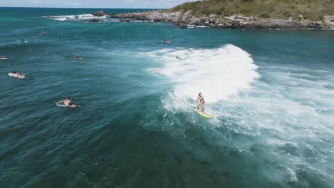 woman surfer riding an epic wave in maui, hawaii, usa