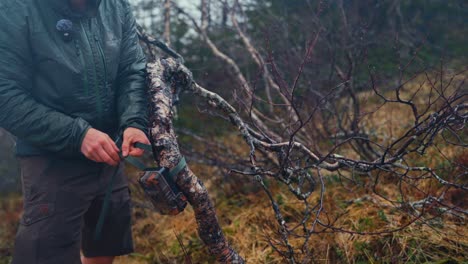 Man Installing Trail Camera On a Tree. - closeup shot
