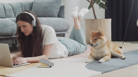 Mujer-Joven-Que-Trabaja-En-Su-Computadora-Portátil-En-Casa-Junto-A-Su-Perro-4