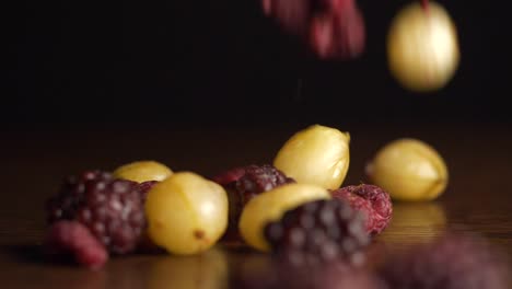 assorted dried berries and grapes on wooden surface