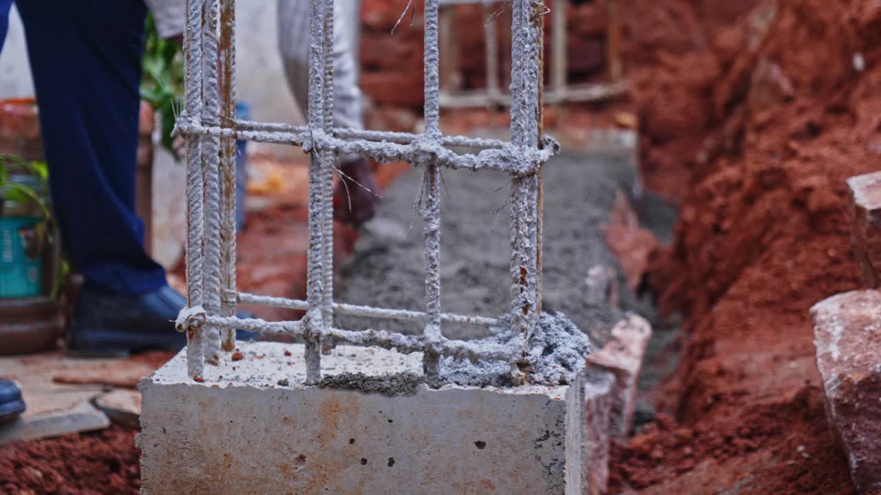 Rusted rebar column with cement mortar levelling on basement work at construction site, hyderabad, telangana, india. day time, stable shot, 4k