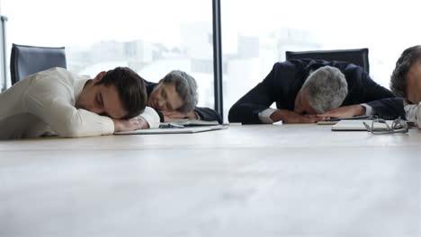 Business-people-sleeping-on-table