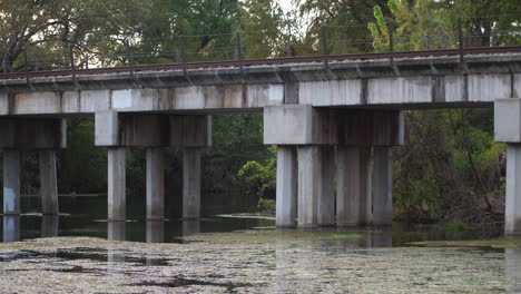 static shot of an old train bridge on the san marcos river on a long lens