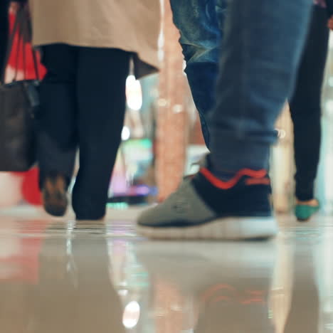 people walking in a shopping center. close-up of feet. shopping time. square video