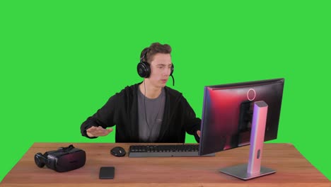 excited gamer playing online video game on a green screen, chroma key