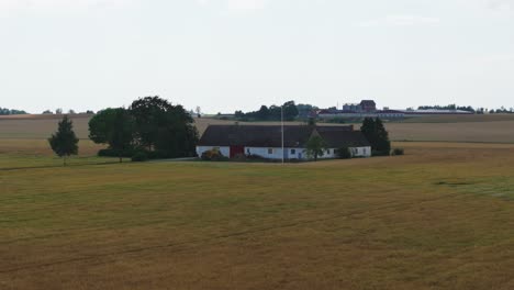 farm building surrounded by fields and grassland in the countryside