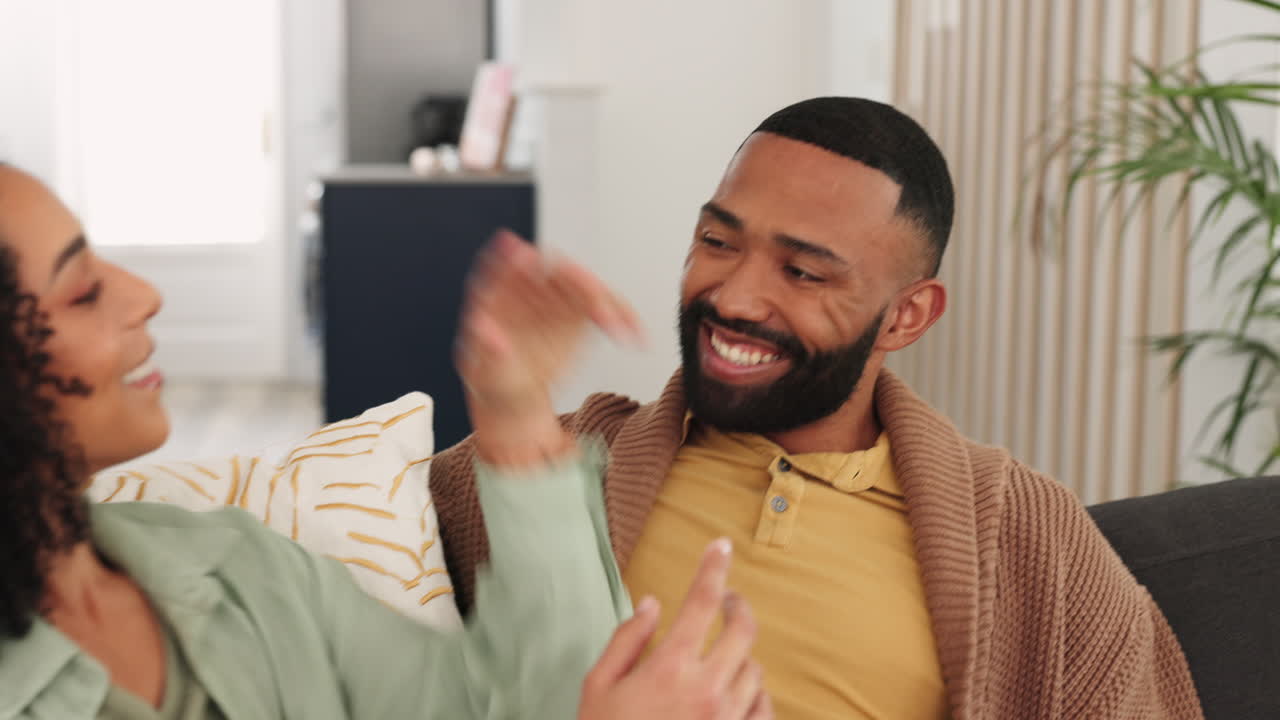 Black couple, talking and relax together on couch