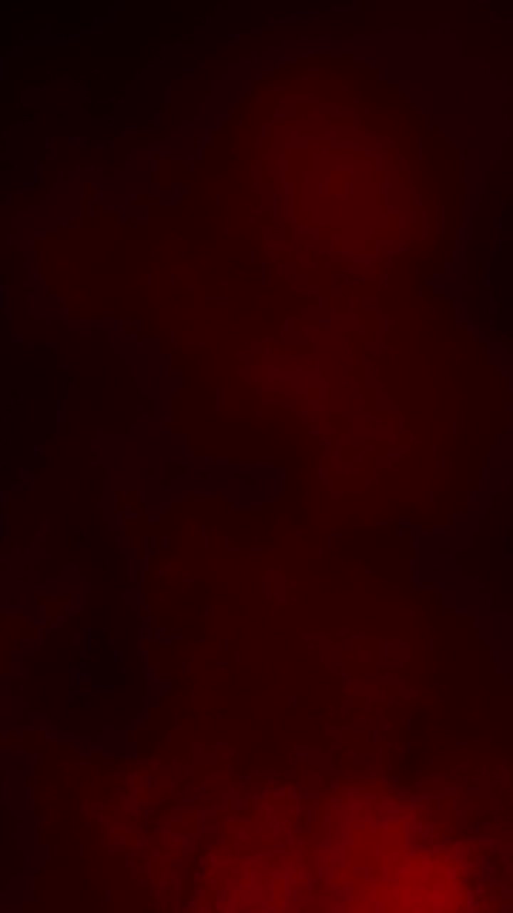 Formato verticale di fumo o nebbia rosso scuro che si espande lentamente su sfondo nero per un'atmosfera suggestiva, loop continuo