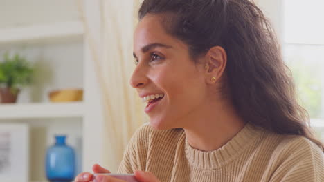 Woman-Relaxing-At-Home-Sitting-At-Table-With-Hot-Drink