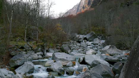 pedestal drone shot of river maggia's glacial waters flowing down from cristallina mountain, to the village of cavergno, in vallemaggia district, in the canton of ticino, in switzerland