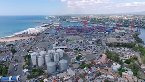 aerial flyover industrial port of haina with cranes in city of santo domingo