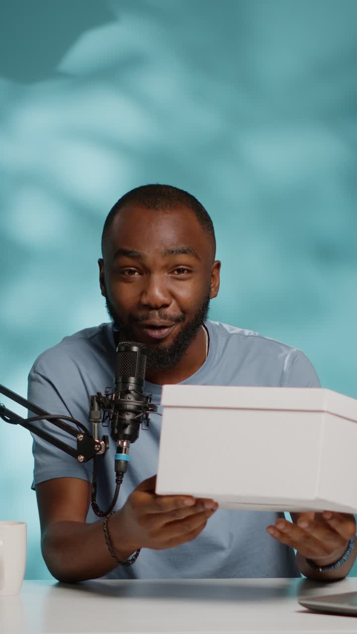 Podcast with a man holding a box