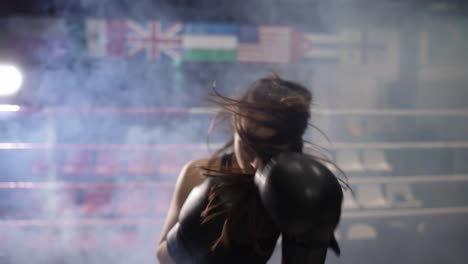 Female-Boxer-Punching-Camera-During-Training,-Shadow-Boxing-During-Workout-In-Dark-Gym