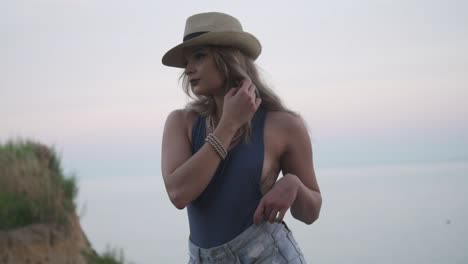 a beautiful model standing and striking side pose during photo shoot near the shallow ocean in ontario, canada - close up shot