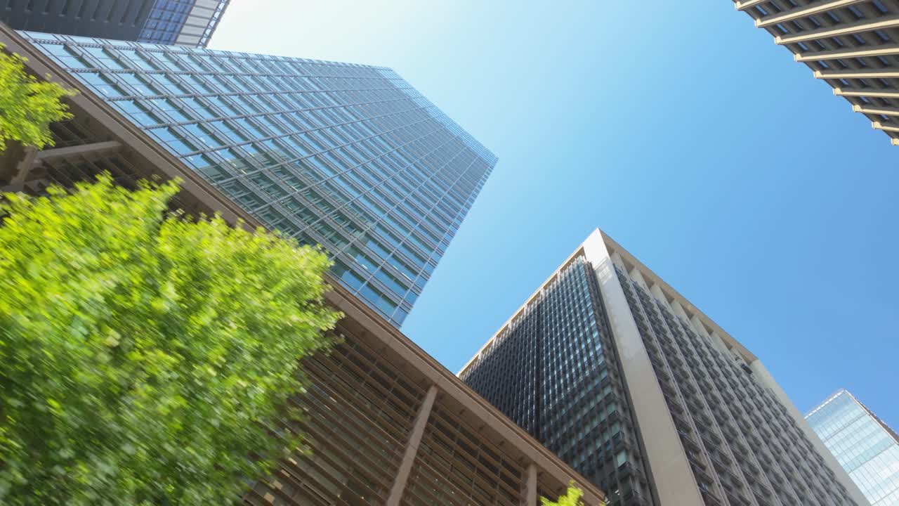 The architectural splendor of Marunouchi Square from a low vantage point, showcasing Tokyo’s dynamic skyline.