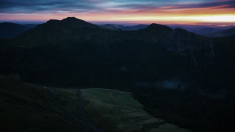 drone wide panorama of volcanoes at sunset during golden hour in auvergne, france