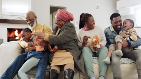 big family, living room and tickle hug on sofa