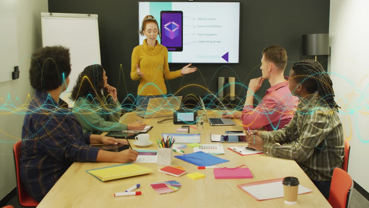 Presenter leading design meeting, gesturing and causing waveform growth across table