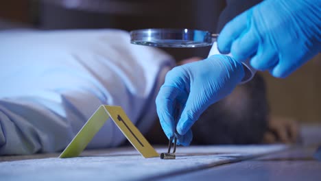 criminology. forensic expert examining detonated shell casings at the criminal site.