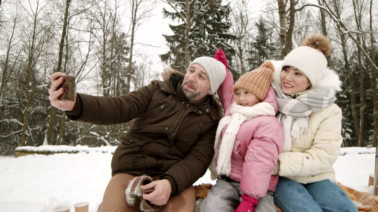 familia tomando una selfie en la nieve