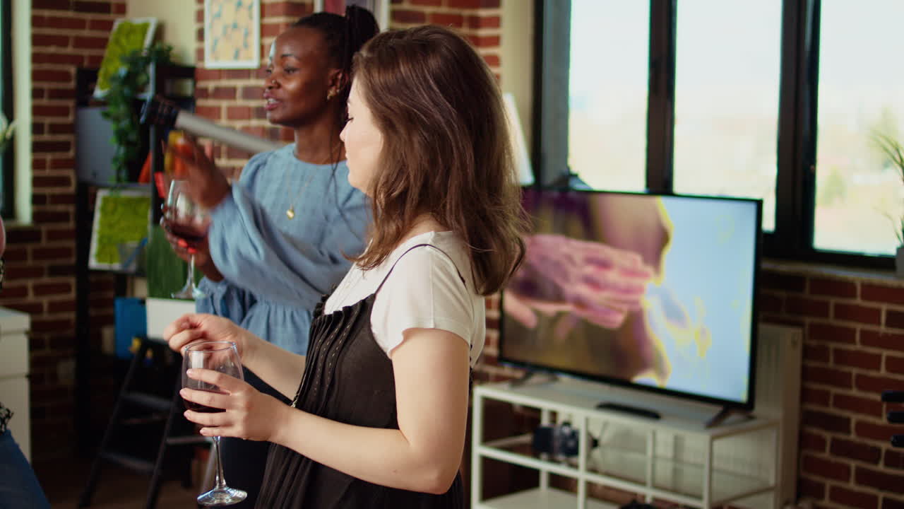 Colleagues organizing apartment party, enthusiastically dancing to Hiphop music