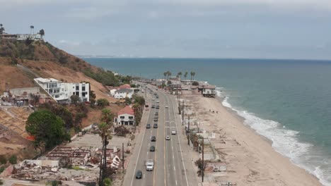 low aerial shot flying over pacific coast highway near las flores canyon after the wildfire in malibu, california. 4k