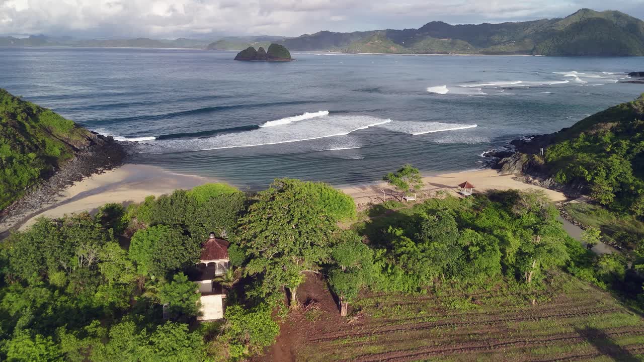 Flyover quiet empty sand beach on tropical Lombok Indonesia shore