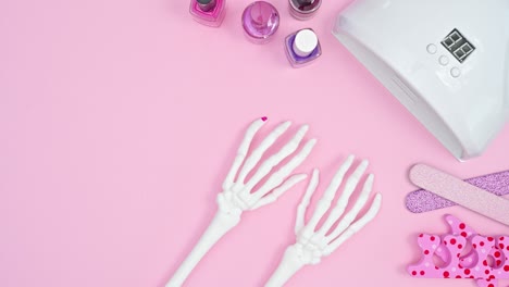 creative manicure on skeletal arms and using uv lamp. stop motion