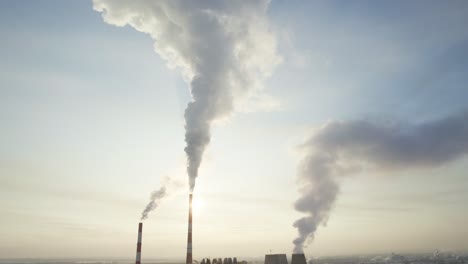 factory smoke stacks on a sunny morning