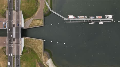 Traffic-flow-over-bridges-at-Haringvliet-locks,-Stellendam,-aerial-top-down