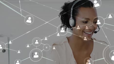 Animation-of-networks-of-connections-with-icons-over-businesswoman-using-phone-headsets