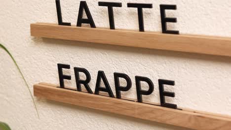 wooden menu board with latte and frappuccino display
