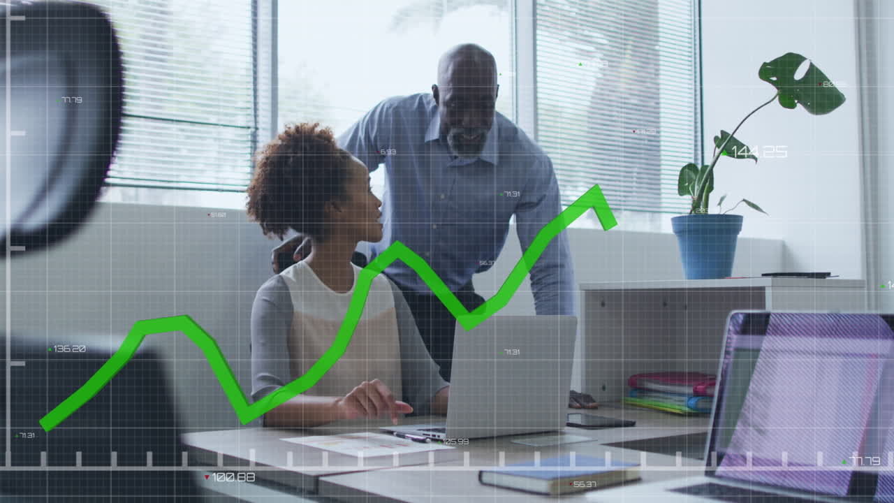 Animation of graph with changing numbers over diverse coworkers discussing reports on laptop