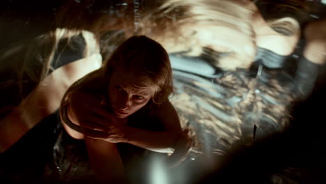 astonished woman looking at distorted reflections surrounding her