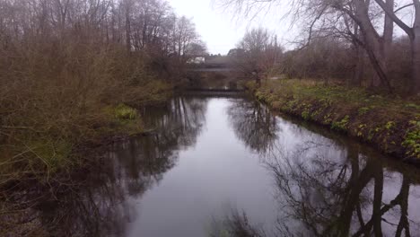 Fluss-Little-Ouse,-Fliegen-über-Wasser-In-Richtung-Straße,-Waldgebiet-In-England