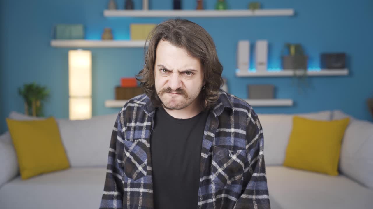 화난 남자가 카메라를 쳐다보고 있습니다. 제스처.