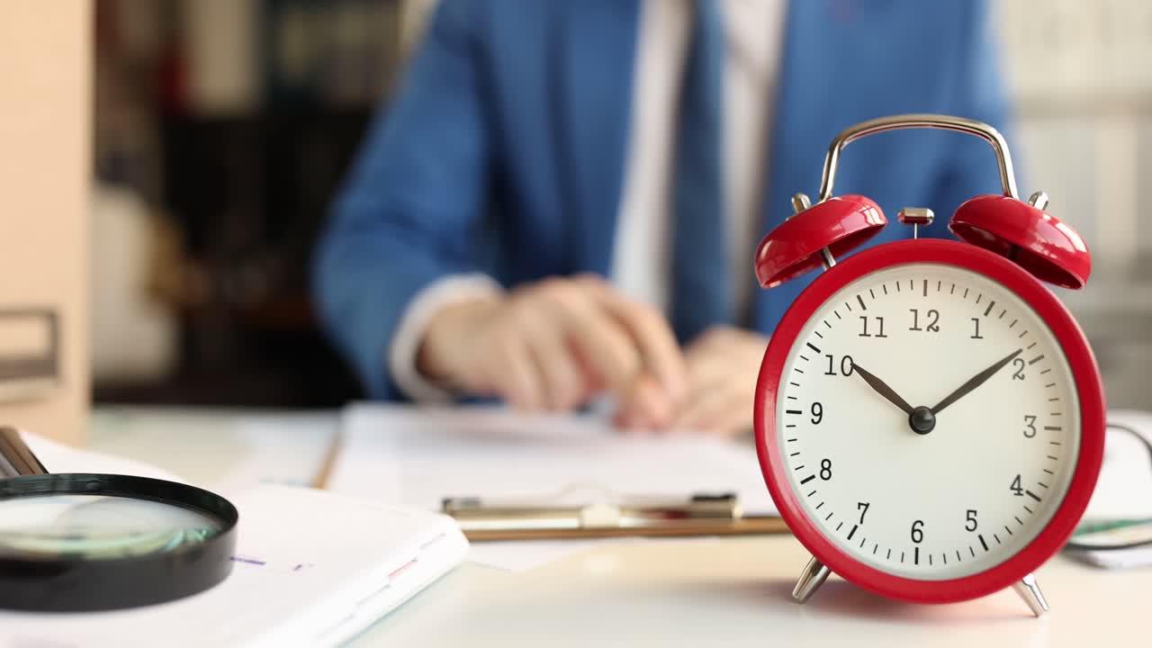 Businessman at Desk with Alarm Clock