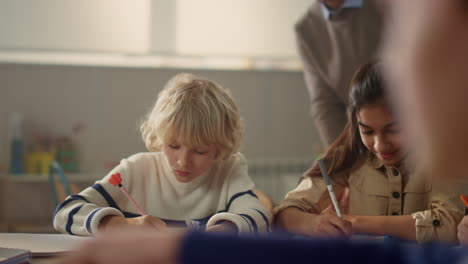 schoolchildren writing in notebooks. students making notes in exercise books