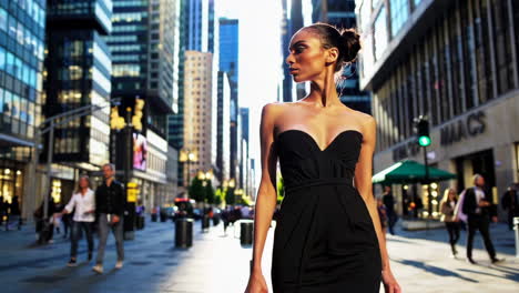 stylish woman in a black dress on a city street