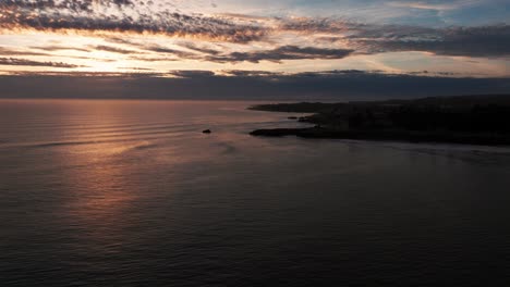 Drone-shot-flying-in-towards-surfers-in-the-ocean-near-dusk-in-California