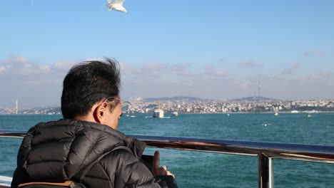 Man-At-The-Seaside-Using-Smartphone-To-Take-A-Photo