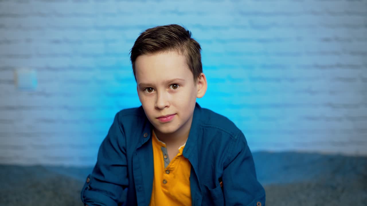 Boy puts on face medical mask against bacteria and viruses. Self isolation and self quarantine to help stop the spread of coronavirus