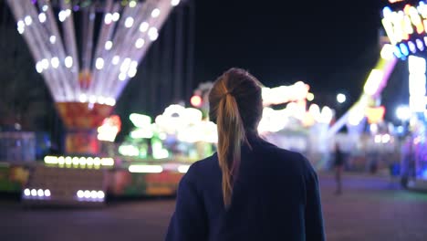 Back-view-of-young-attractive-girl-with-ponytail-walking-forward-then-turning-around-smiling-and-looking-at-camera-hanging-out