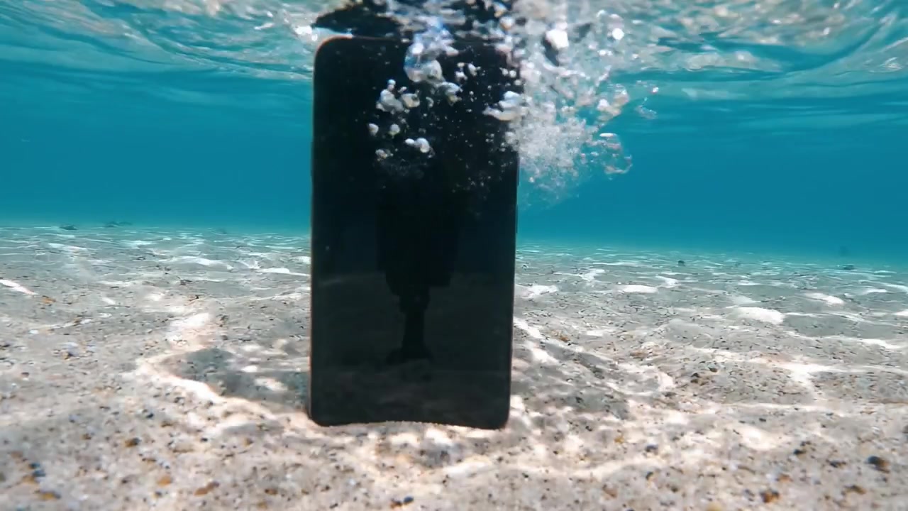 Incontro subacqueo con uno smartphone: uno sguardo affascinante al viaggio della tecnologia sotto le onde in un ambiente acquatico cristallino