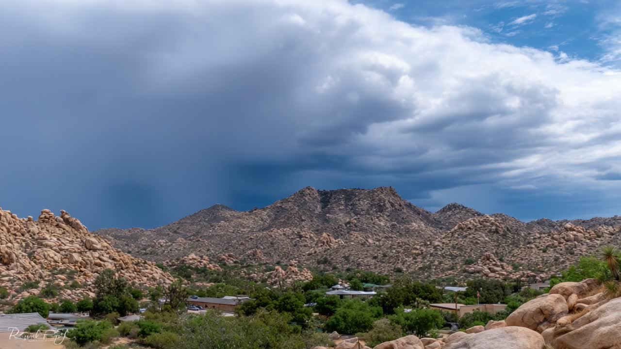 Expansive View of Dramatic Landscape with Mountains and Dynamic Skies: A Stunning Contrast Between Rocks and Storm Clouds