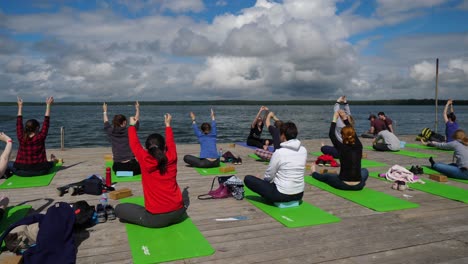 group yoga session by the lake