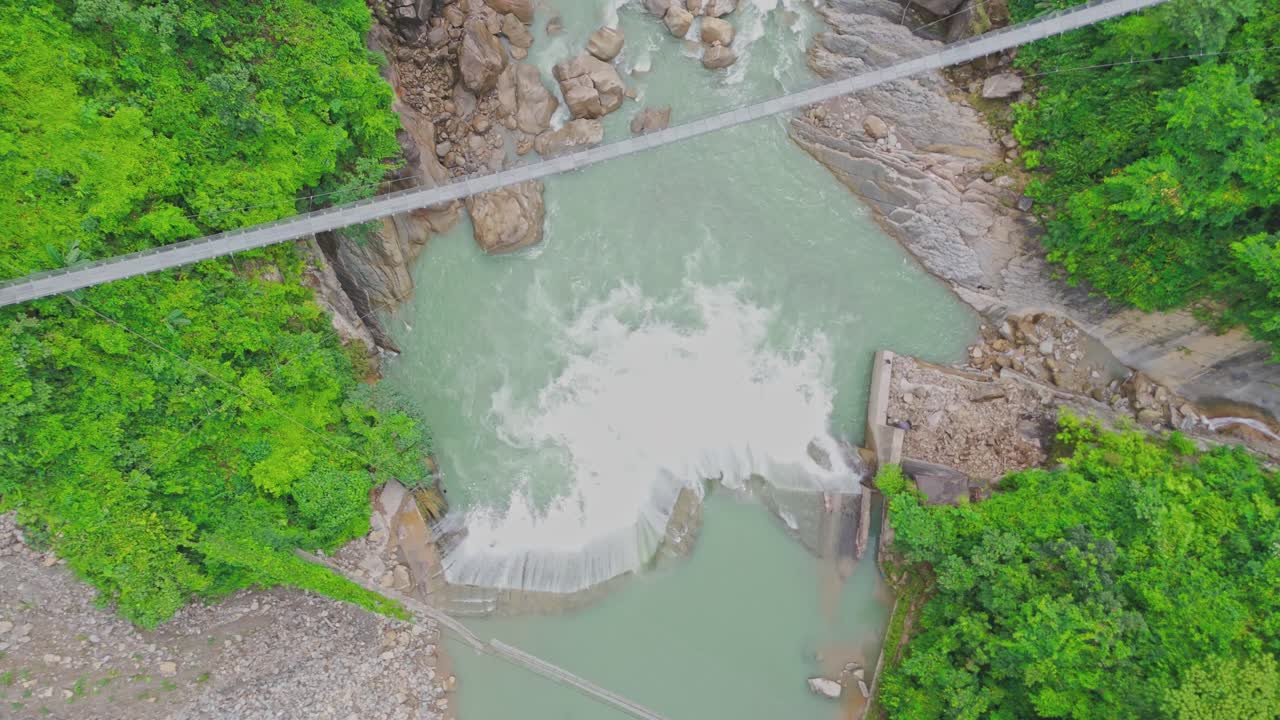A breathtaking aerial view of a beautiful waterfall cascading through lush green mountains, showcasing the untouched beauty of nature, flowing water, and serene landscape scenery