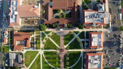 aerial view of a university campus courtyard with palm trees and fountain