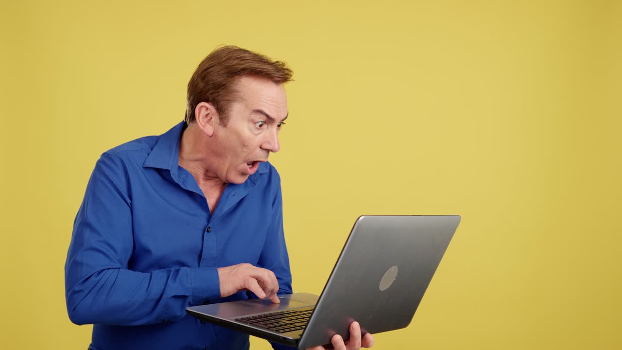 Shocked man looking at a laptop